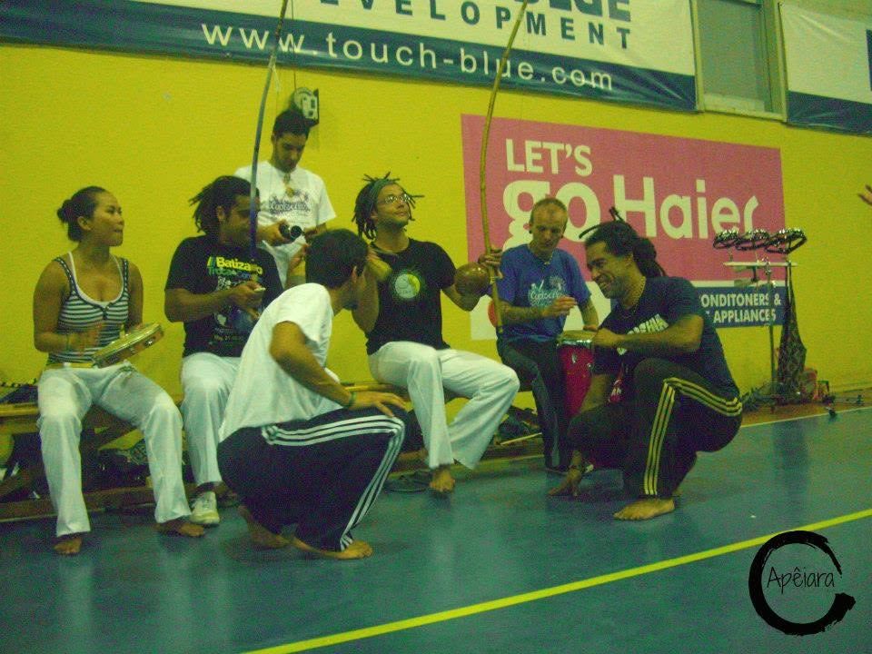 Two capoeiristas crouched at the foot of the bateria before a game at the first Cyproeira in 2010